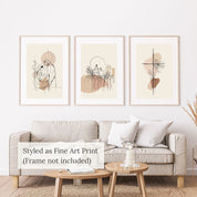 Three framed abstract art prints on a wall above a sofa in a living room setting.