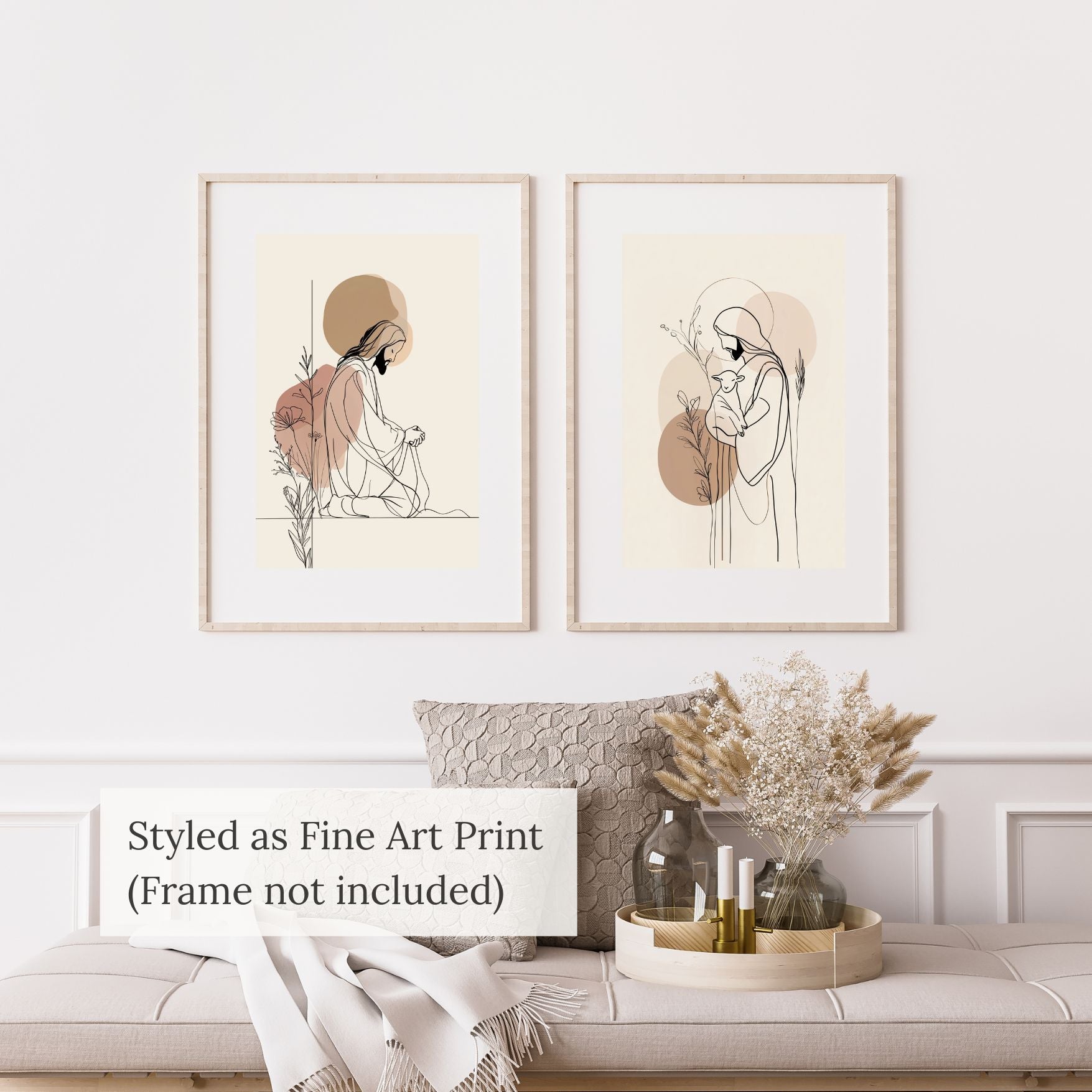 Two framed art prints on a wall above a sofa with decorative items.