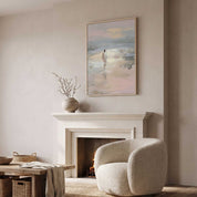 Framed christian artwork on Jesus Walking on the water displayed above a white fireplace in a neutral living room, with a cream armchair and wooden coffee table.