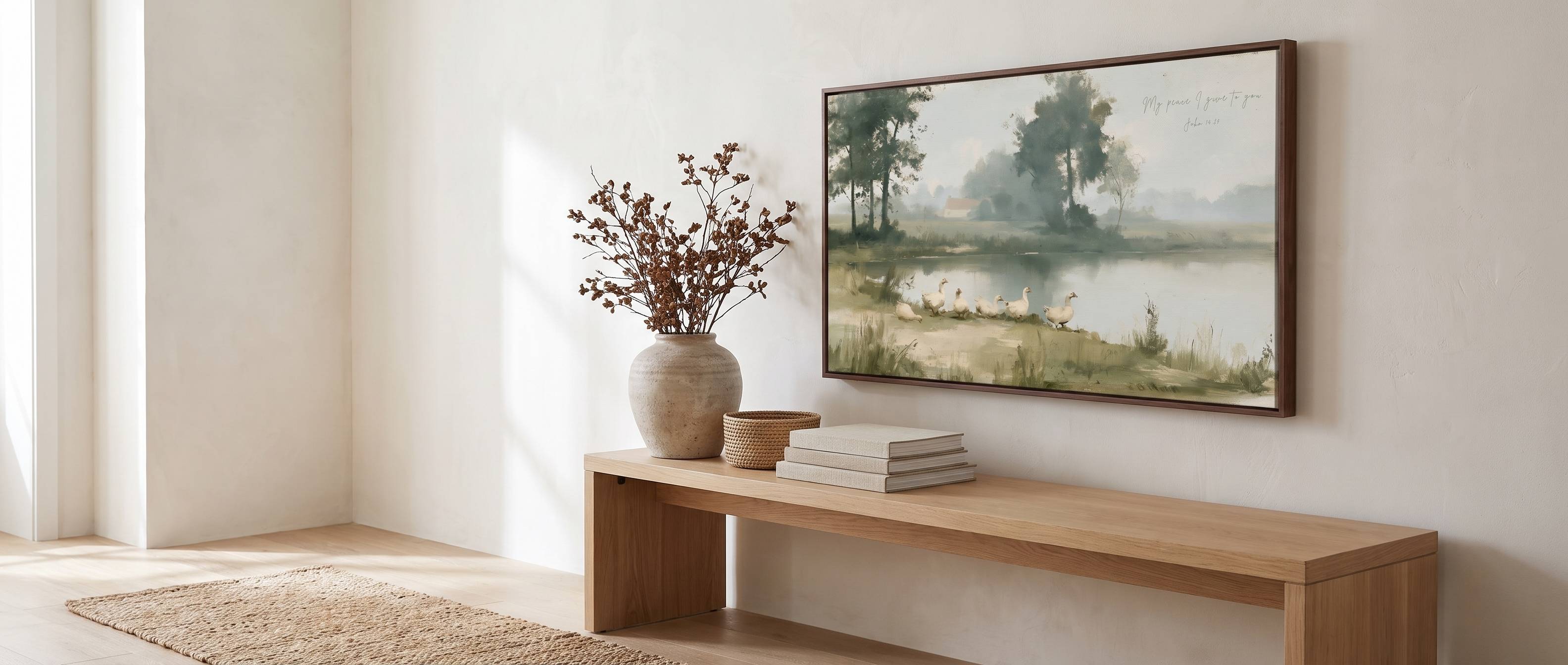Lamb's Love framed Christian gospel-centered wall art honoring God's creation, featuring a scenic landscape painting displayed above a beige sofa in a modern living room setting.
