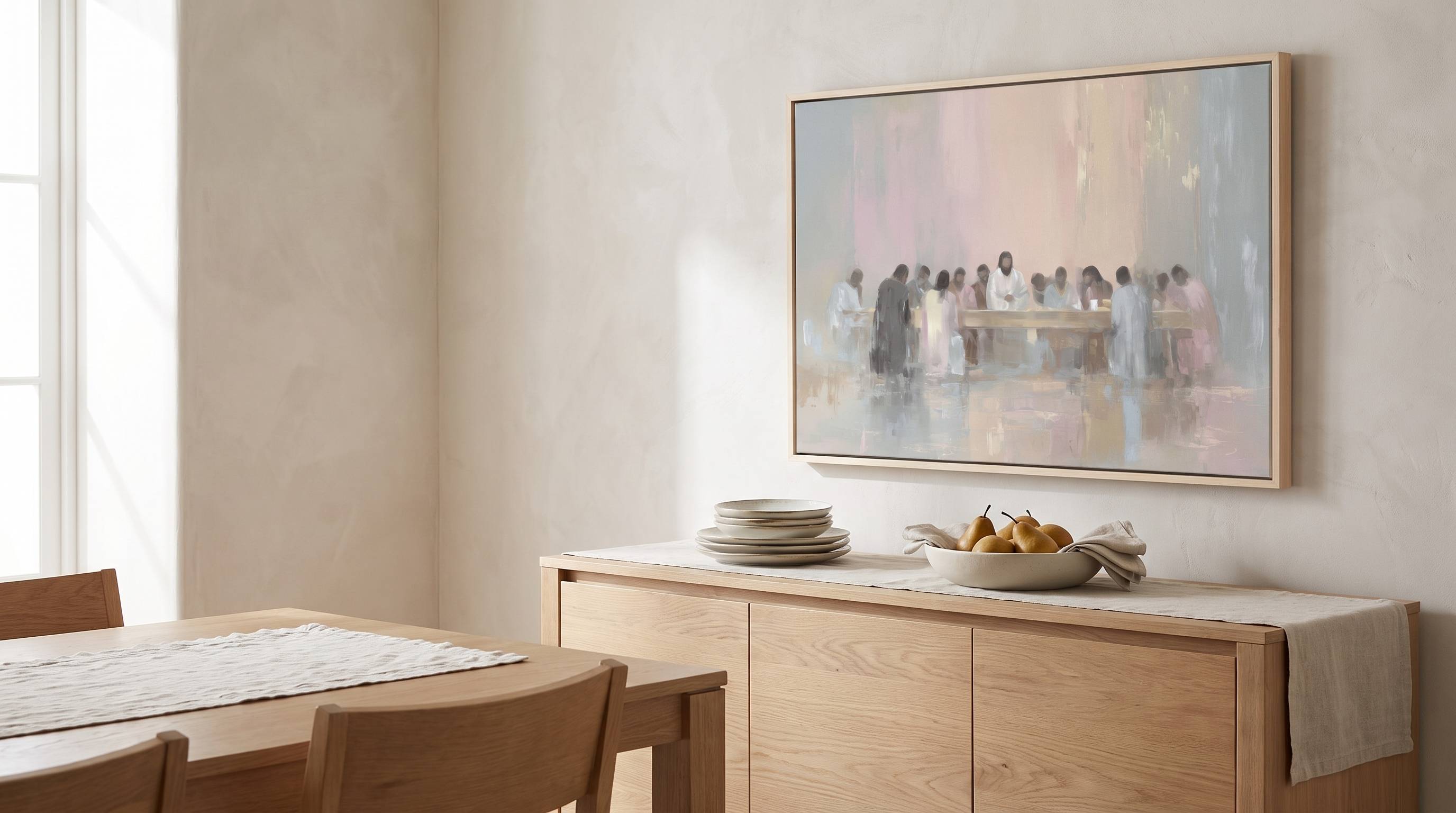 Minimalist modern framed canvas art of The Last Supper in soft pastel tones hanging on a beige wall above a light wood sideboard in an organic modern dining room.