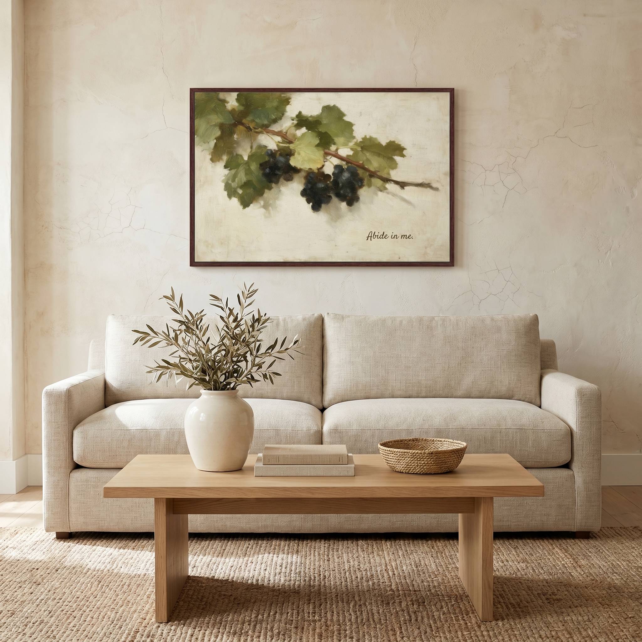 Abide in Me Christian wall art displayed above a modern living room sofa, featuring a vintage grapevine design inspired by John 15 in a bright, minimalist home.
