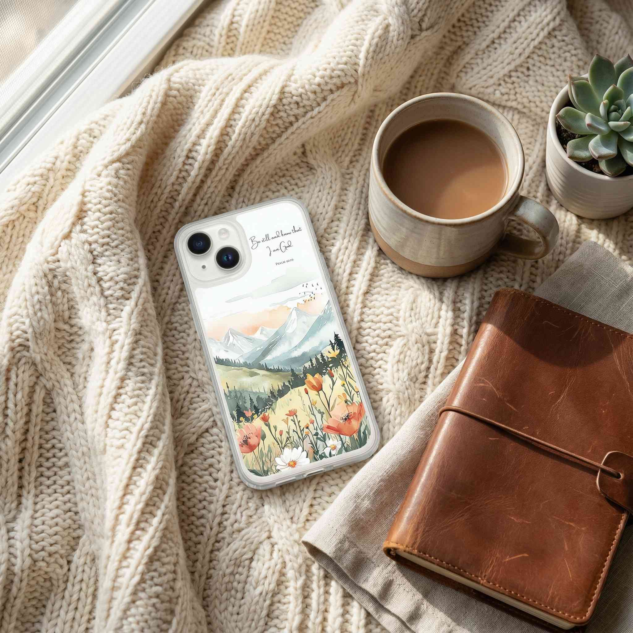 Phone case with nature design on a textured surface with a cup of coffee and notebook.