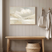 Framed vintage Christian winter landscape wall art titled Be Still and Know with Psalm 46:10 verse, displayed on a paneled wall above a light wood bench with wall hooks in a styled entryway.