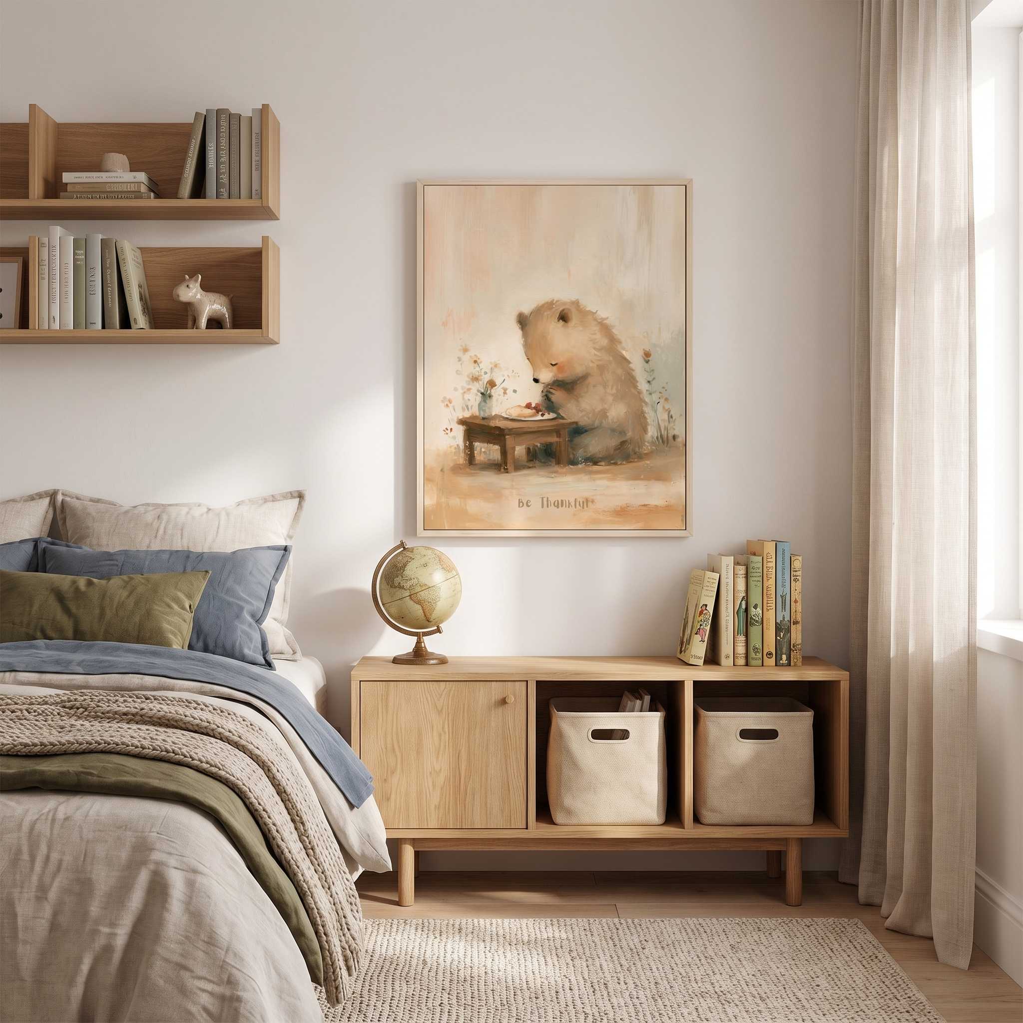 Be Thankful praying bear Christian kids wall art in a light wood frame above a cabinet with books and a globe, beside a bed with blue bedding.