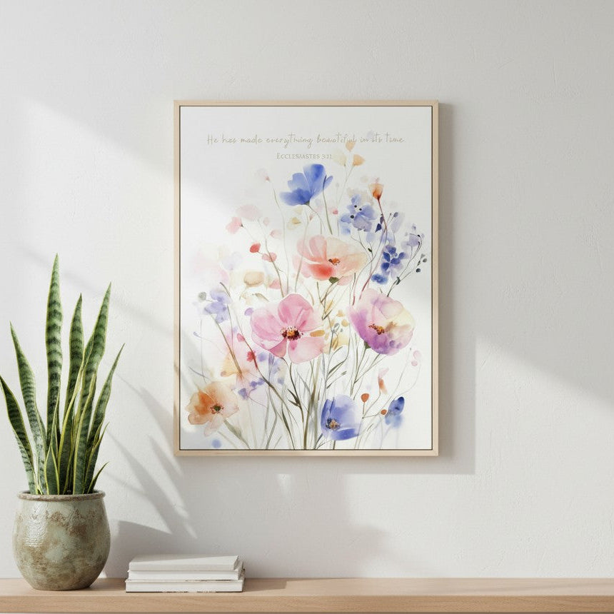 Framed watercolor wildflower Scripture wall art featuring Ecclesiastes 3:11, displayed on a white shiplap wall beside a vase.