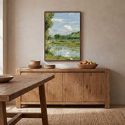 Framed Beside Still Waters Christian wall art displayed in a rustic dining room above a natural wood sideboard with serene river landscape watercolor.