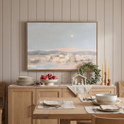 Framed Star of Bethlehem Nativity wall art showing a peaceful town beneath a radiant star, displayed above a wooden sideboard in a dining room.