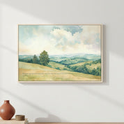 Watercolor landscape Scripture wall art with green hills and sky, framed above a table.