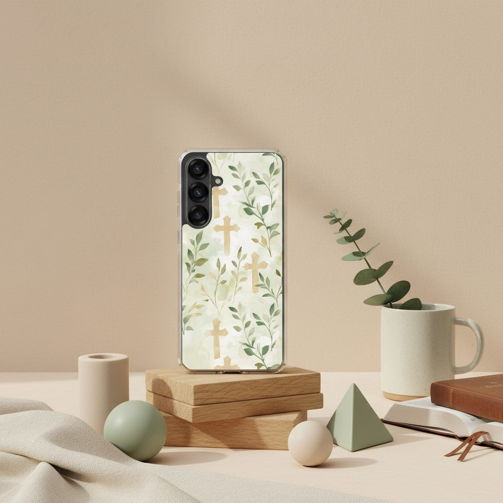 Botanical cross Samsung phone case with soft green leaves forming cross pattern displayed on wooden stand with neutral decor and eucalyptus in minimalist studio setting