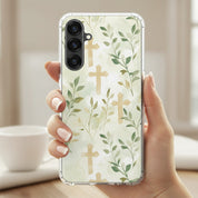 Botanical cross Samsung phone case with green leaves forming cross pattern held in hand in soft natural light minimalist Christian faith design