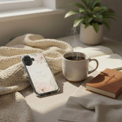 By Grace Through Faith MagSafe® clear iPhone case featuring elegant floral artwork and Ephesians 2:8 scripture beside a warm coffee mug, devotional journal, and soft knit blanket in a cozy Christian morning setting