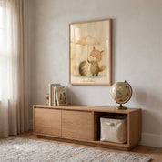Framed Care for Others fox and hedgehog Christian kids wall art above a wooden cabinet with books and a globe in a neutral children’s room.