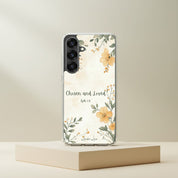 Chosen and Loved Christian Samsung phone case with yellow floral design and Ephesians 1:4 Bible verse, displayed on a minimalist beige stone podium.