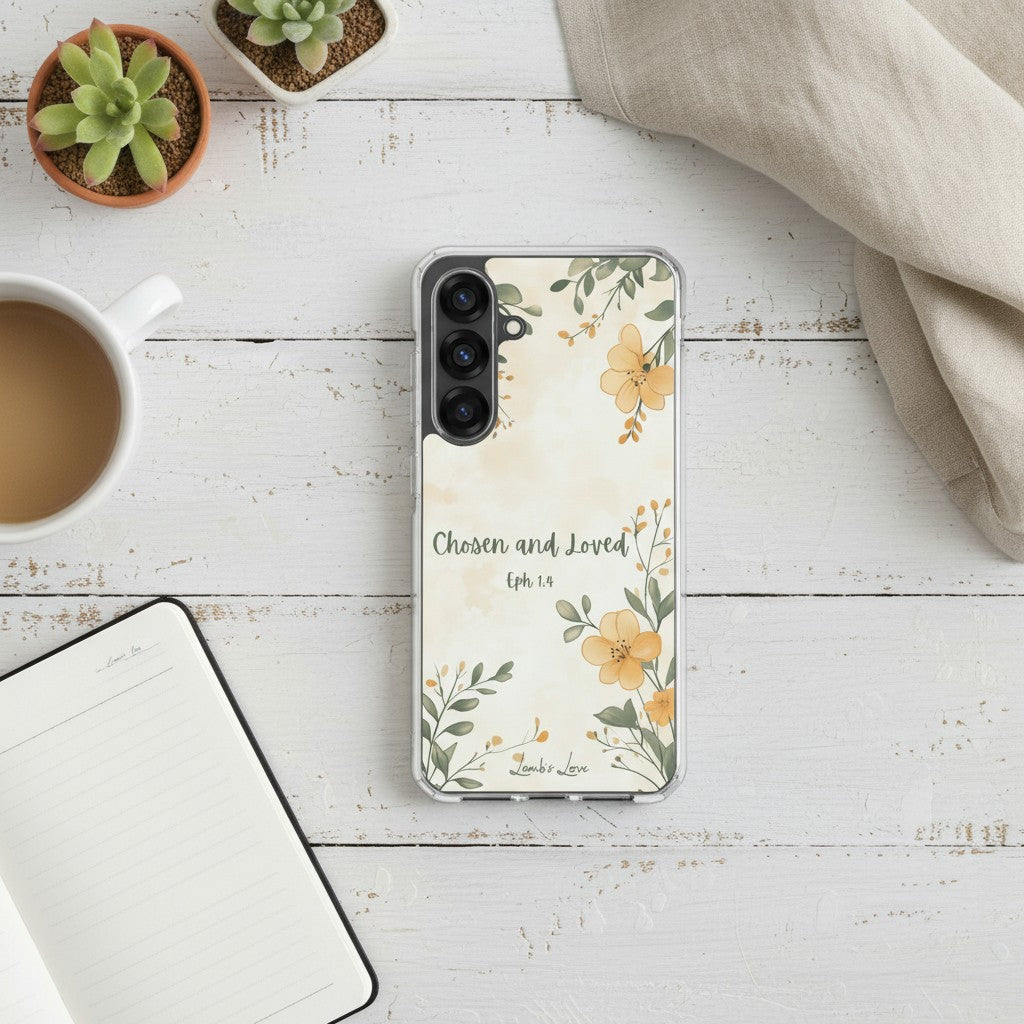 Chosen and Loved Christian Samsung phone case with yellow floral design on a white painted wood desk next to a coffee mug, succulent plant, and open notebook.