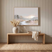Framed watercolor landscape wall art celebrating God’s creation, displayed on a beige paneled entryway wall above a light wood bench with dried flowers.