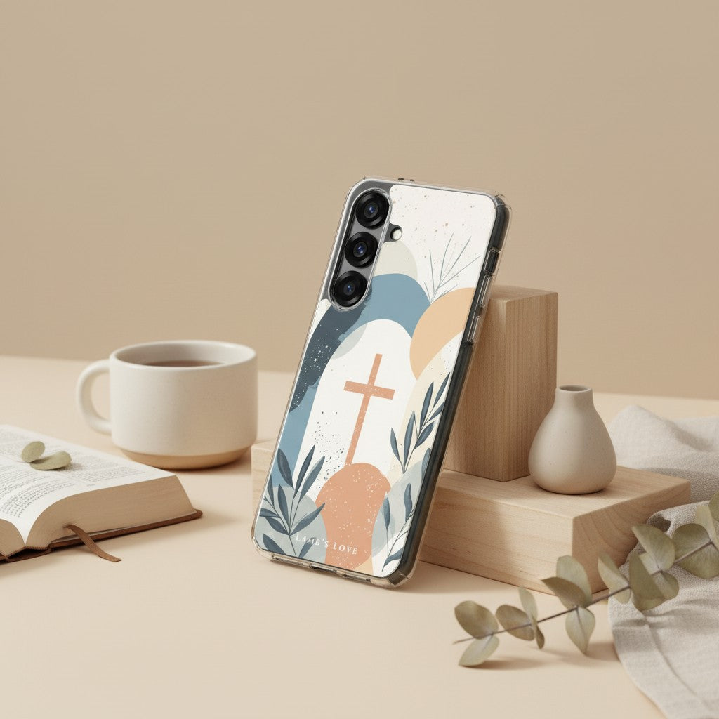 Minimalist Christian Samsung Galaxy case with a tan cross and abstract nature design on a wooden pedestal next to a white coffee mug, an open book, and a small vase