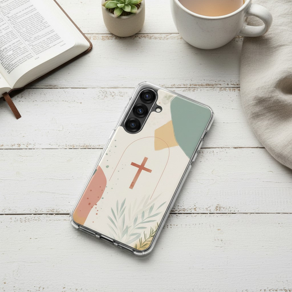 Christian cross Samsung phone case with minimalist beige botanical design on white painted wooden table with Bible and coffee mug in soft natural light symbolizing faith in Jesus Christ