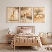 Three framed neutral Christian kids wall art prints depicting a deer, a fox, and a sleeping lamb displayed above a light wood bed with blush pink bedding in a children's bedroom.