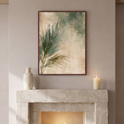 Framed Christian palm leaf wall art above a stone fireplace mantel with a ceramic vase and candle, bringing botanical faith decor to a cozy home.