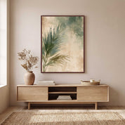 Framed Christian palm leaf wall art above a light wood media console in a warm neutral living room with natural botanical decor.