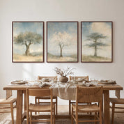 A three-piece framed Christian wall art triptych featuring botanical tree prints displayed above a wooden dining table and chairs in a neutral dining room.