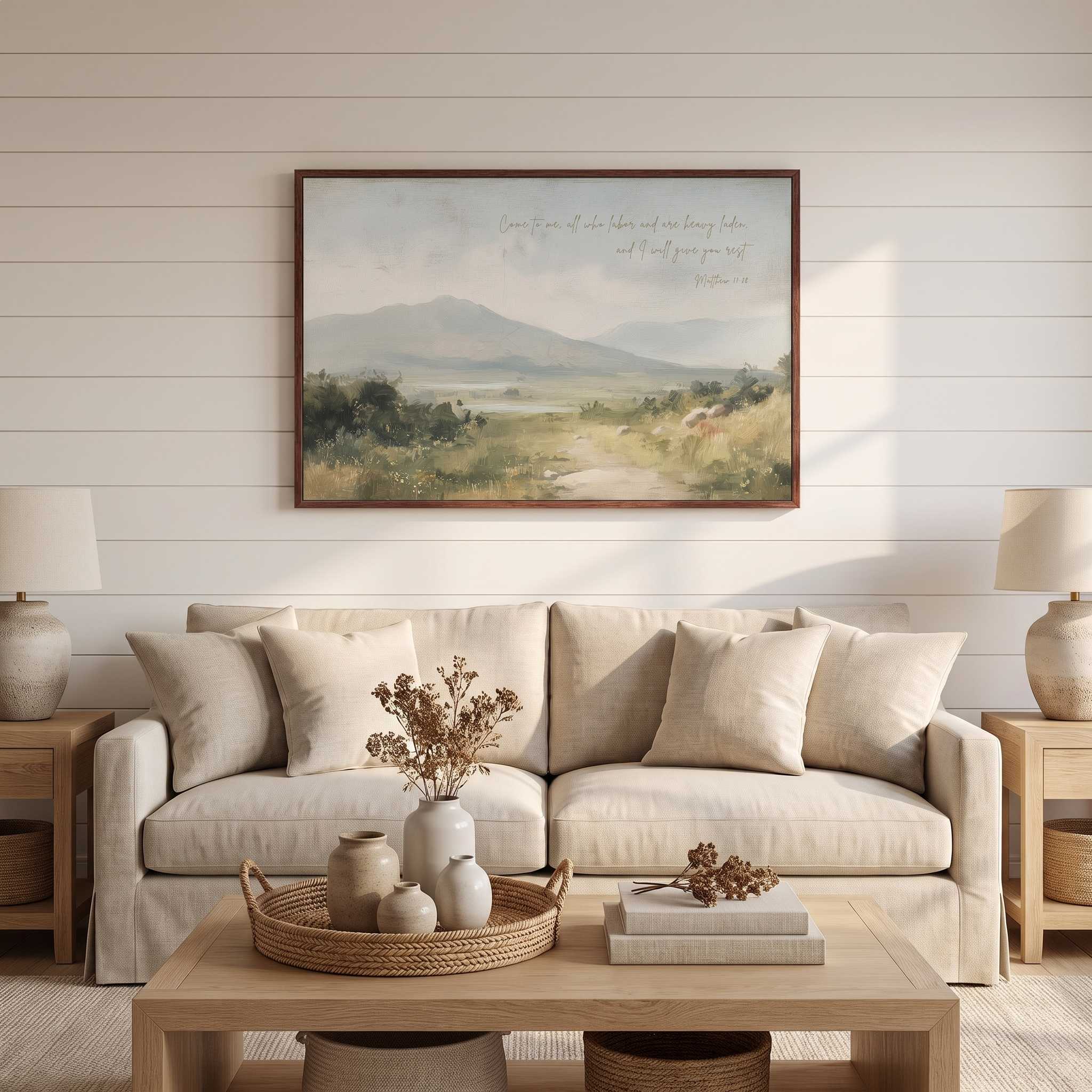 Framed vintage Christian landscape wall art titled Come to Me with Matthew 11:28 verse, displayed on a shiplap wall above a beige sofa in a soft organic modern living room.