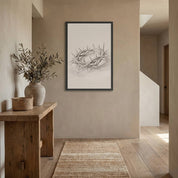Minimalist Crown of Thorns line art sketch in a black frame, styled on a neutral wall in a modern entryway with a wooden console table.