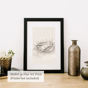 Minimalist Crown of Thorns line art sketch in a black frame, styled as a fine art print on a wooden table with rustic vases.