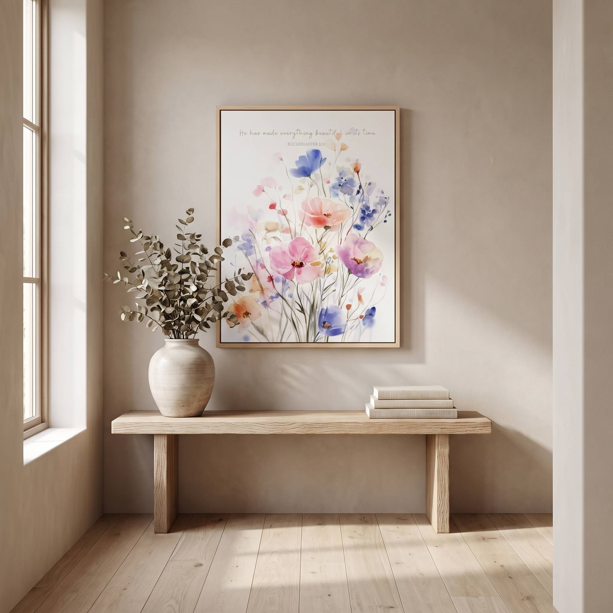 Ecclesiastes 3:11 Christian floral wall art above a light wood hallway bench, with pastel watercolor wildflowers and a vase of greenery.
