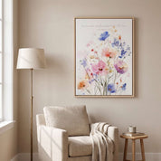 Ecclesiastes 3:11 watercolor floral wall art above a cozy armchair in a reading nook, with pastel wildflowers and a soft neutral interior.