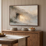 Framed abstract Empty Tomb Jesus Risen Christian landscape canvas wall art hanging above a rustic wooden sideboard with stacked plates and a fruit bowl in a warm dining room.