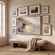 Framed abstract Empty Tomb Jesus Risen Christian landscape canvas wall art featured as a center piece in a gallery wall above a wooden bench with a beige cushion in a warm room.
