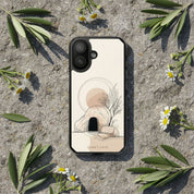 Empty Tomb Christian MagSafe iPhone case on natural stone surface surrounded by olive leaves and wildflowers with peaceful resurrection-inspired aesthetic