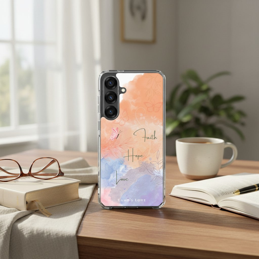 aith Hope Love Christian Samsung phone case with watercolor floral design on a wooden desk alongside an open Bible, reading glasses, a notebook, and a white coffee mug in a bright, sunlit room.