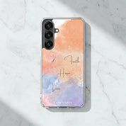 Faith Hope Love Christian Samsung Galaxy phone case featuring a pastel watercolor floral design with peach and lavender tones on a white marble background.