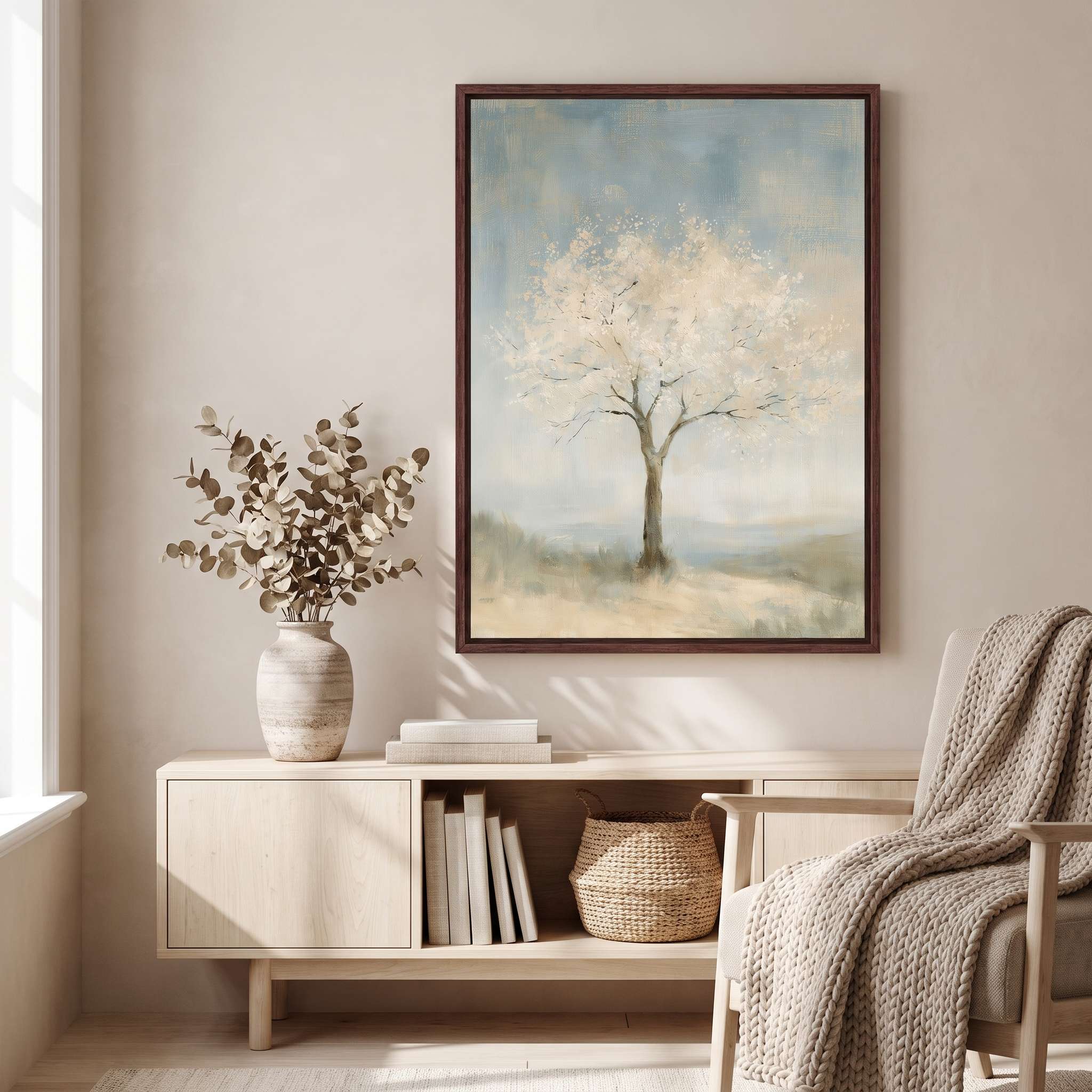 Framed Faithful to His Word almond blossom tree Christian wall art above a light wood console with books and a vase beside a chair with a knitted throw.