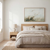 Framed vintage Isaiah 41:10 landscape canvas wall art hanging above a light wood bed in a soft organic modern bedroom.