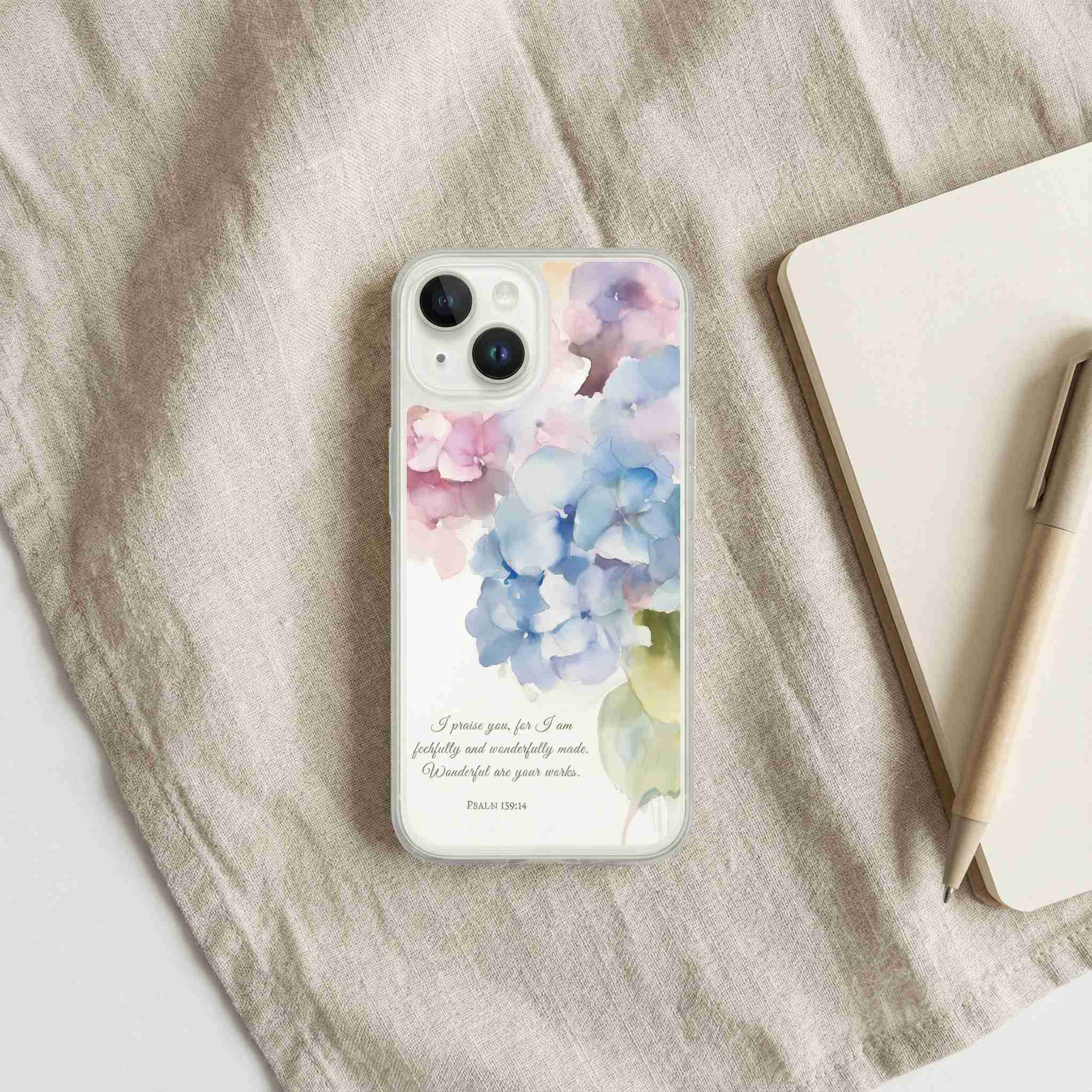 Phone case with floral design and text on a fabric surface
