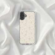 Floral Cross Christian iPhone case featuring delicate neutral watercolor wildflowers with subtle Christian cross details displayed on elegant soft white silk fabric in a feminine minimalist aesthetic setting