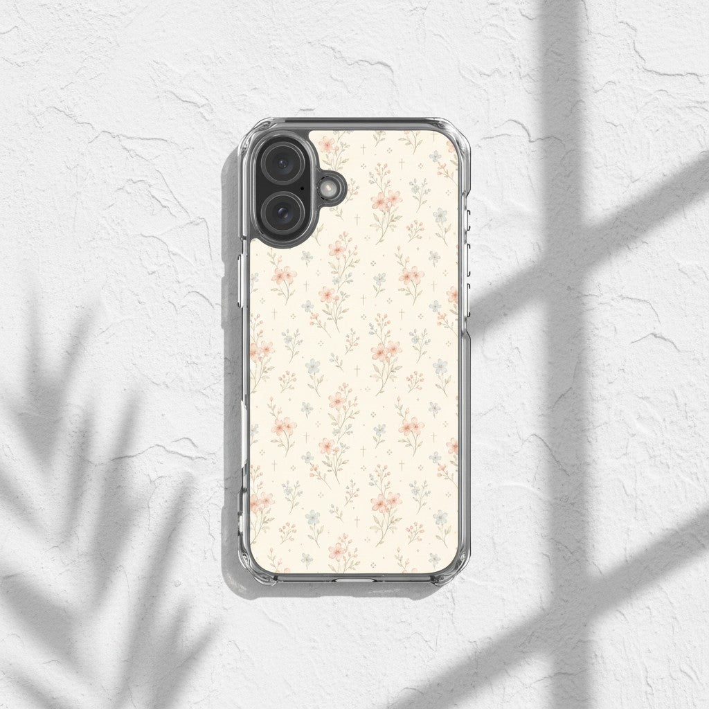 Floral Cross Christian iPhone case featuring soft neutral watercolor wildflowers with subtle Christian cross details displayed on a textured white surface with warm sunlight and botanical shadows in an elegant feminine aesthetic setting