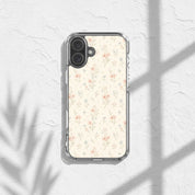 Floral Cross Christian iPhone case featuring soft neutral watercolor wildflowers with subtle Christian cross details displayed on a textured white surface with warm sunlight and botanical shadows in an elegant feminine aesthetic setting