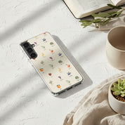 Fruits of the Spirit Christian Samsung phone case with colorful fruit illustrations on white surface with coffee cup Bible and plant in soft sunlight Galatians 5:22-23 love joy peace faithfulness
