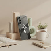 God Is Good Christian Samsung Galaxy phone case with cross and infinity symbol displayed on desk with Bible, coffee cup, and plant faith lifestyle scene