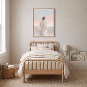 Framed watercolor wall art of Jesus the Good Shepherd holding a lost lamb above a light wood bed in a soft neutral children’s bedroom, a gentle Christian nursery decor idea.
