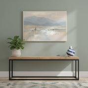 Framed Good Shepherd wall art of Jesus and His sheep on a misty mountain shore, displayed on a sage green wall above a console table.