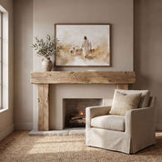 Jesus the Good Shepherd Christian wall art inspired by John 10:11, framed above a rustic fireplace mantel beside a neutral armchair in a cozy living room.