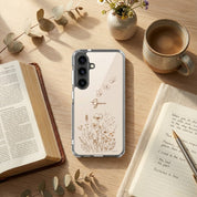 Grace Christian Samsung Galaxy phone case with wildflowers and butterfly design on wooden table beside open Bible, notebook, and coffee faith lifestyle scene