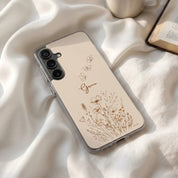 Grace Christian Samsung Galaxy phone case with wildflowers and butterfly design on soft fabric beside coffee and open Bible faith lifestyle scene