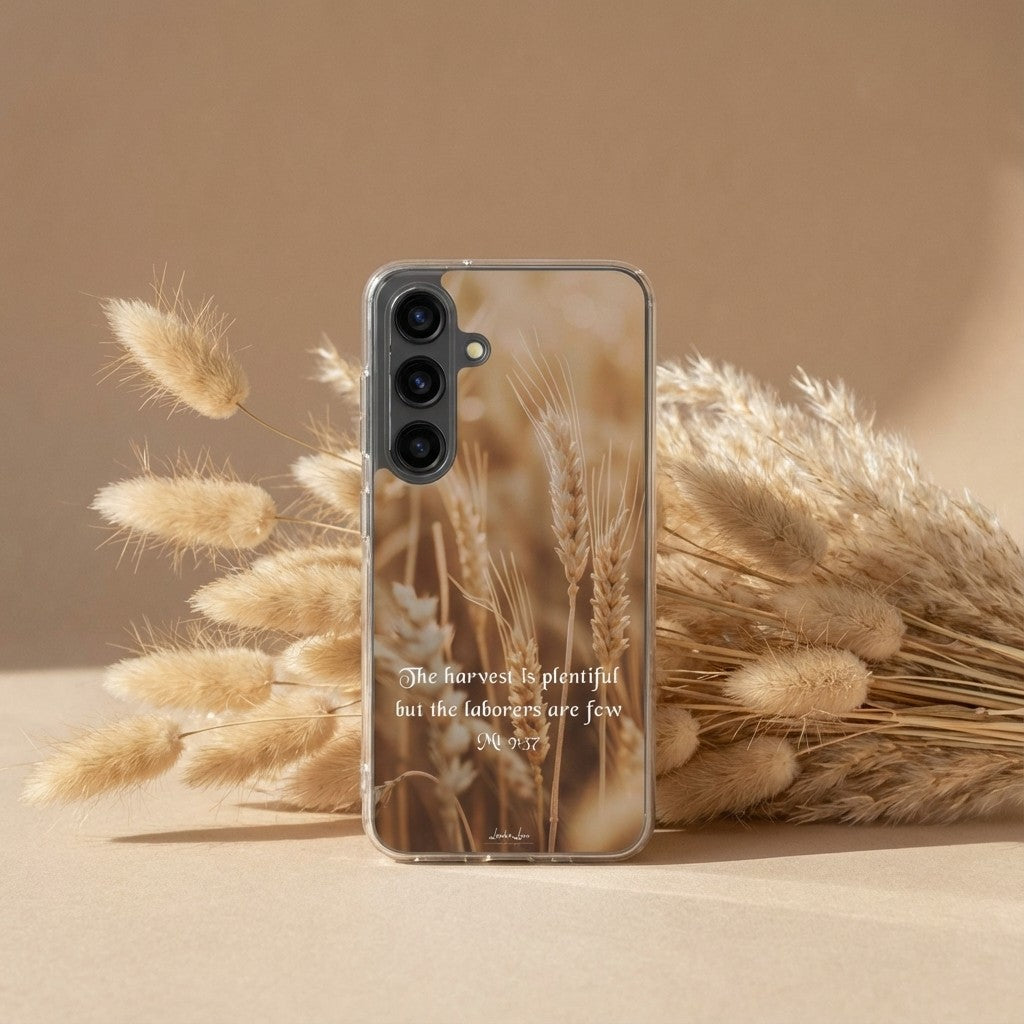 Phone case with wheat design and text, surrounded by wheat on a beige background